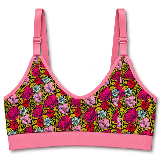 SWOOP wireless bra with bright pink straps and band, featuring a colorful floral print on the cups with pink, red, blue, and green flowers on a yellow background.