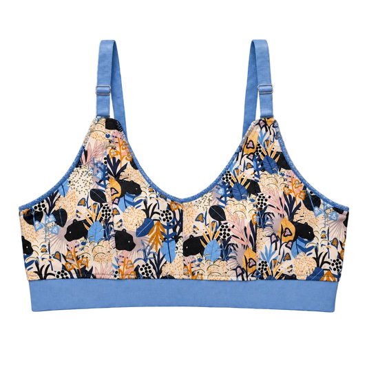 SWOOP wireless bra with light blue band and straps. Adjustable rings and sliders in the front. Print is repeating small panthers in a multi-colored floral scene.