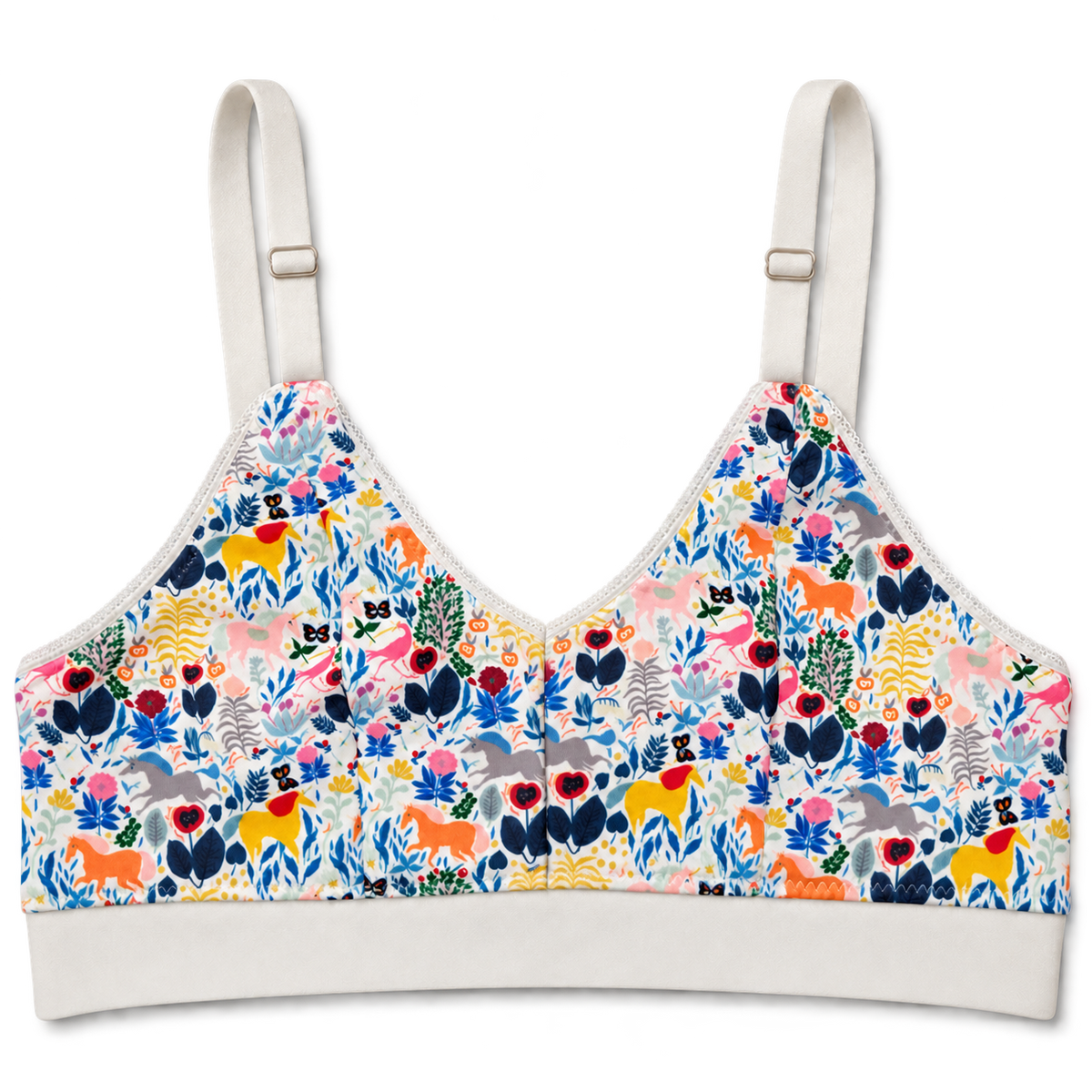 SWOOP wireless bra with adjustable shoulder straps and a white band, featuring a vibrant multicolor unicorn and floral print on a white base, shown against a plain white background.